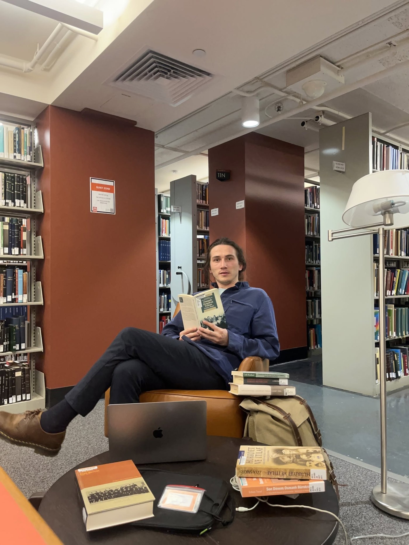 Muhammet Topal reading in a library